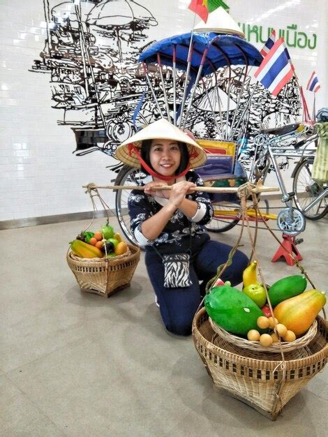 Premium Photo Portrait Of Smiling Mid Adult Woman Holding Baskets