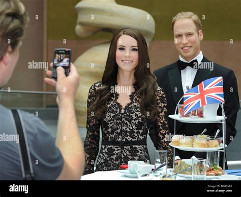 The Wax Figures Of Prince William And Duchess Kate Stand Behind A Table Which Has Been Laid For