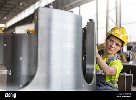 Female Steel Worker Examining Steel Part In Factory Stock Photo Alamy