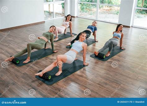 Reversed Plank Group Of Women Practicing Fitness In The Gym Stock