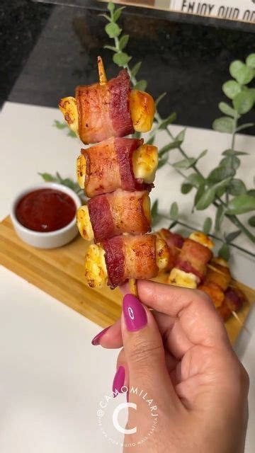 Someone Is Holding Up Some Bacon Wrapped Food