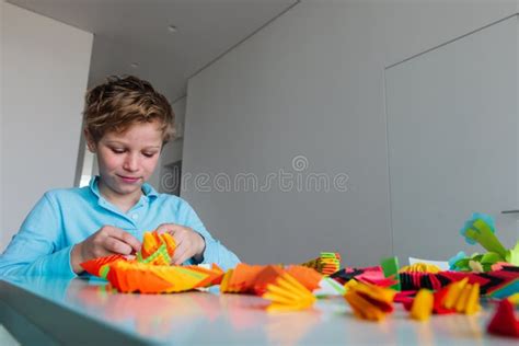 Boy Making Origami Crafts with Paper, Learning through Play Stock Photo ...