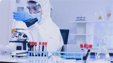 Scientist In Ppe Suite Doing Some Research Checking A Liquid In A Test