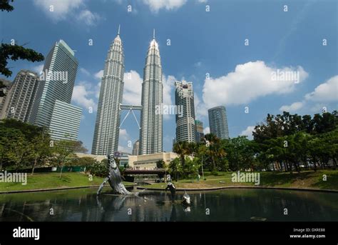 Kuala Lumpur City Center Park With Lake In Foreground And Petronas