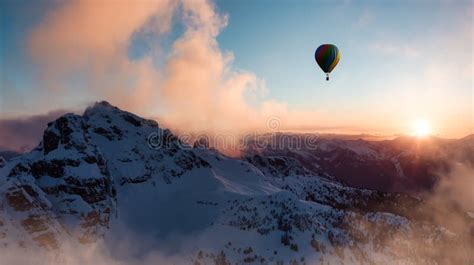 Dramatic Mountain Landscape Covered In Clouds And Hot Air Balloon Flying Stock Photo Image Of