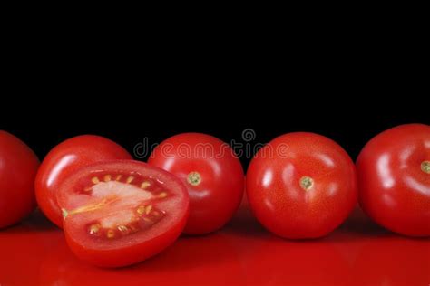 Fresh Red Roma Tomatoes On Red Table And Black Background Copy Stock