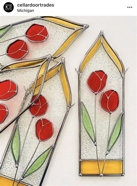 Three Stained Glass Vases With Red Flowers On Them