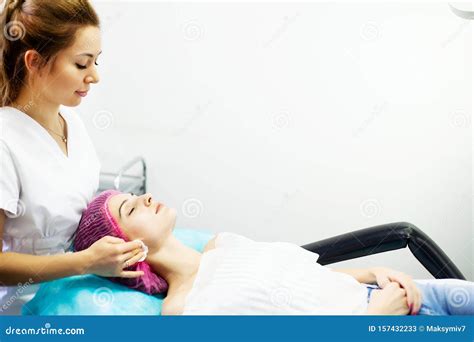 Spa Therapy For Young Woman Having Facial Mask At Beauty Salon Stock