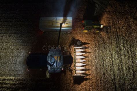 A Claas Lexion Combine Loads The Harvested Corn Onto A Trailer