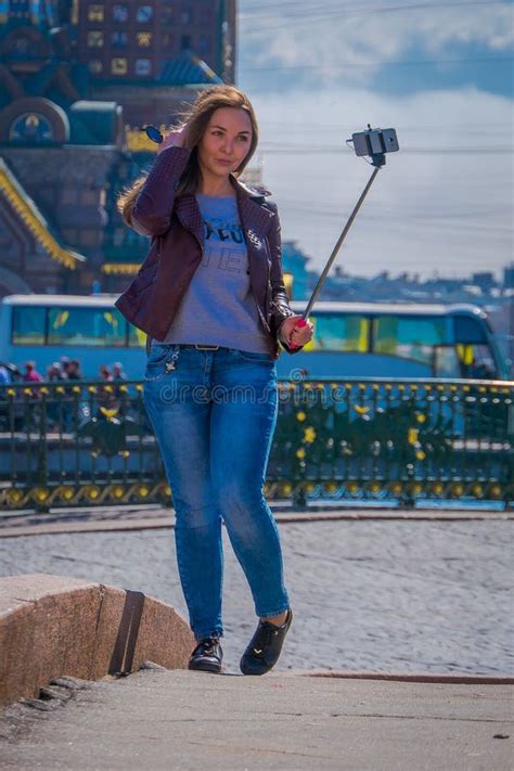 ST PETERSBURG RUSSIA MAY Blonde Russian Woman Wearing Warm Clothes Taking A Selfied