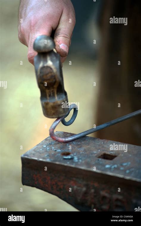Blacksmith Forming A Piece Of Hot Metal Stock Photo Alamy