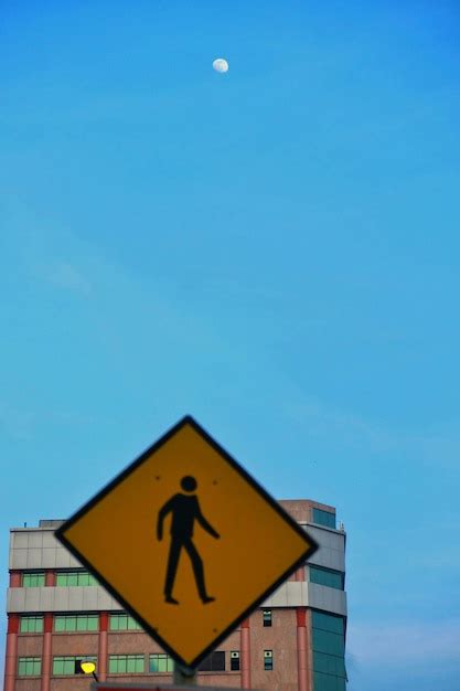 Premium Photo Pedestrian Crossing Sign Against Blue Sky