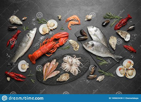 Fresh Fish And Different Seafood On Black Table Stock Photo Image Of