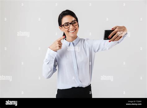 Image Of Attractive Office Woman Wearing Eyeglasses Taking Selfie Photo On Cell Phone Isolated