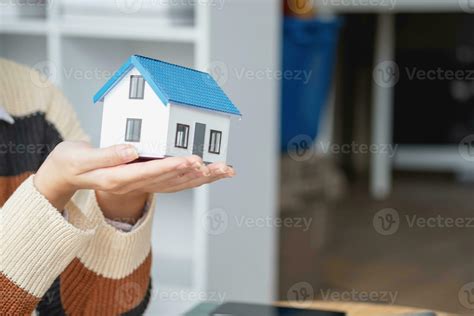 Young Asian woman calculating the cost of selling a house and analyzing