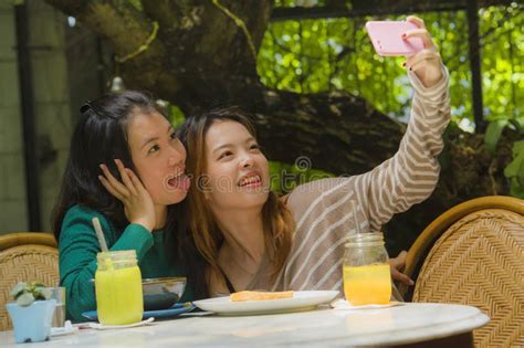 Young Happy And Cute Asian Chinese Girlfriends Taking Selfie Portrait