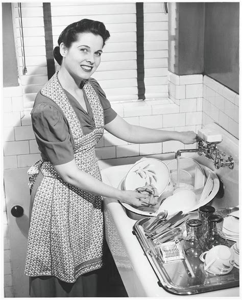 Woman Washing Dishes In Kitchen Sink By George Marks