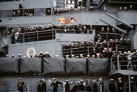 Sailors And Marines Crowd Onto The Port Side Of The Battleship Uss