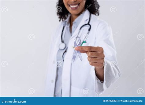 Midsection Of Happy African American Mid Adult Female Doctor With White