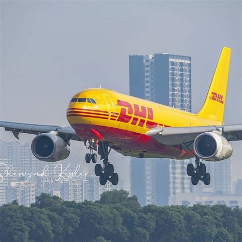 A Yellow And Red Jet Airliner Taking Off From The Runway In Front Of