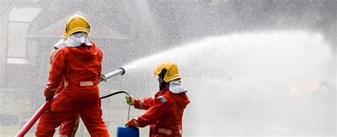 Firefighter Concept Fireman Using Water And Extinguisher To Fighting