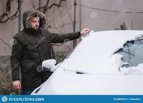 Handsome Man Clean His Car From Snow Using Hands Winter Outdoors Stock