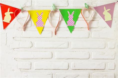 Premium Photo Multi Colored Flags Hanging Against White Wall