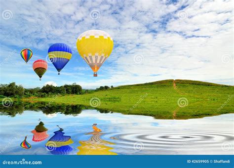 Hot Air Balloon Floating In The Sky Over Land Royalty Free Stock Image