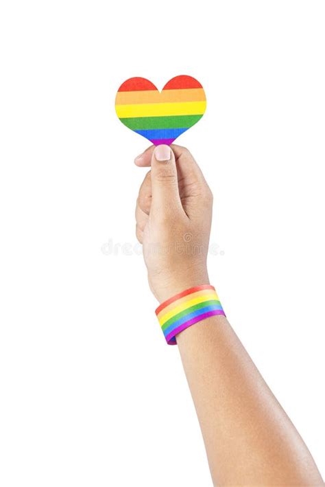 Human Hand with LGBT Rainbow Flag Wristband Holding Rainbow Heart Stock ...