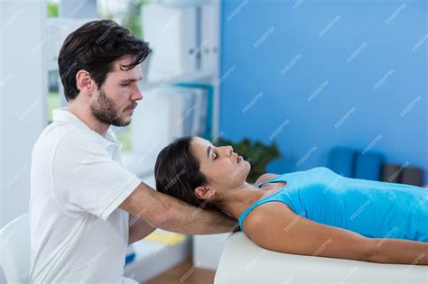 Premium Photo Male Physiotherapist Giving Head Massage To Female Patient