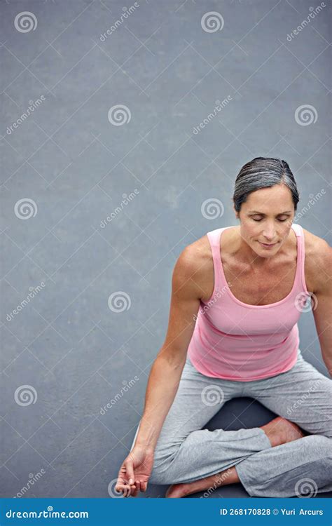 Finding Her Centre An Attractive Mature Woman Practicing Yoga In The