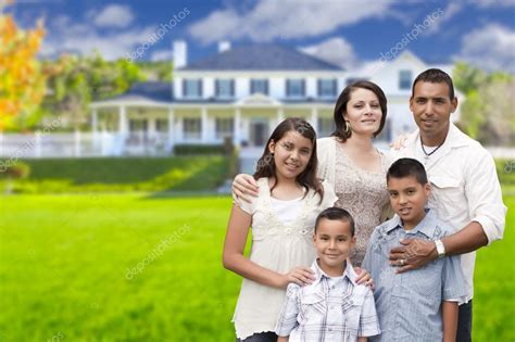 Young Hispanic Family in Front of Their New Home Stock Photo by ...