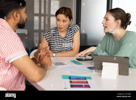 Diverse Team Discussing App Design In A Modern Business Office Mature