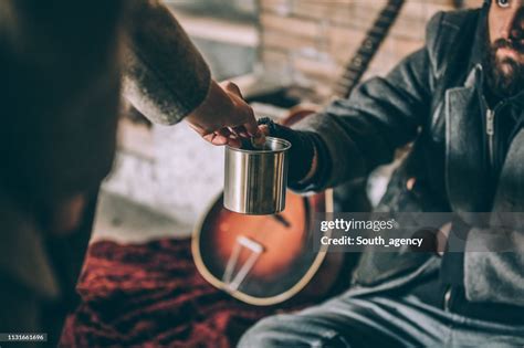 Woman Giving Money To Beggar High Res Stock Photo Getty Images