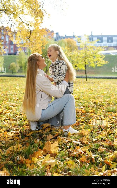 Mother And Daughter Spend Time Together In The Autumn Park Mother