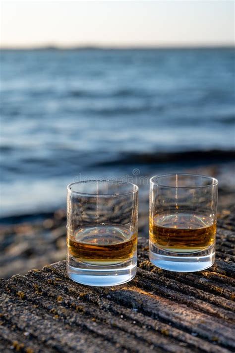 Drinking Single Malt Scotch Whisky At Sunset With Sea Ocean Or River