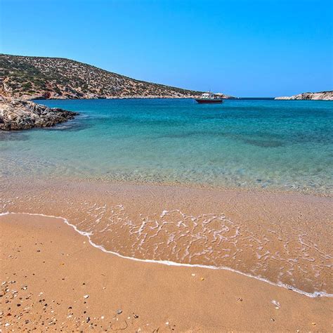 The Beach Is Clear And Blue With Waves Coming In From The Water S Edge