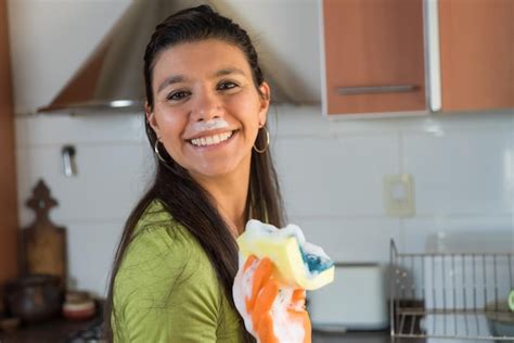 Mulher Sorrindo Lavando Pratos Em Uma Cozinha Grande E Brilhante