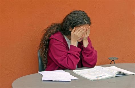 premium photo young woman  head  hands sitting  wall