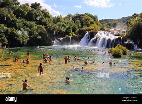 Crowds Of Tourists Taking A Bath In The Waters Of Skradinski Buk