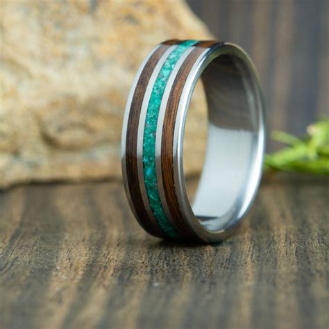 A Wedding Ring With Wood And Turquoise Stone Inlays