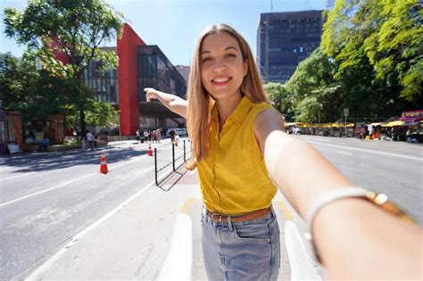 Premium Photo | Travel in sao paulo brazil beautiful smiling girl takes self portrait on ...