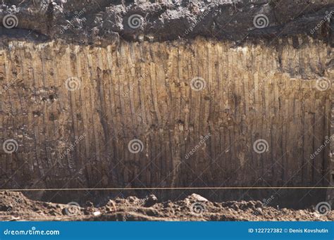 Texture Of Soil With Traces Of A Bucket Of Excavator Wall Ground Of