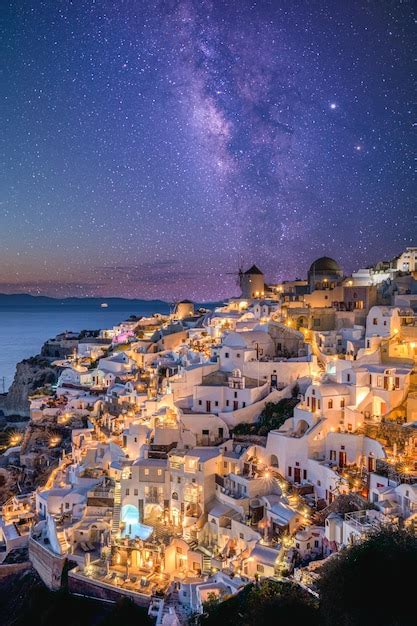 Premium Photo Oia Village In Lights With Stars Milky Way Santorini