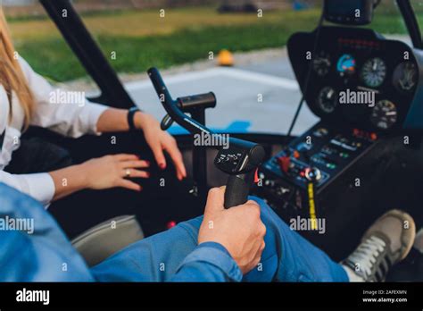Inside View Of A Helicopter In Flight With Man And Woman Pilots Flying