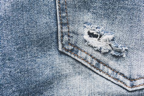 Premium Photo Denim Blue Jeans Texture With Scuffs And Holes