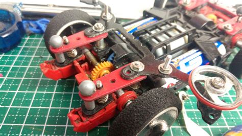 A Close Up Of A Toy Car On A Table With Other Toys And Tools Around It