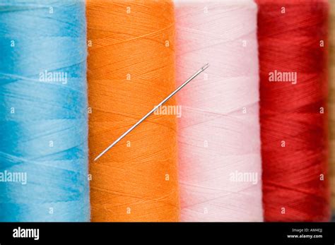 Close Up Of A Needle With Four Spools Of Thread Stock Photo Alamy