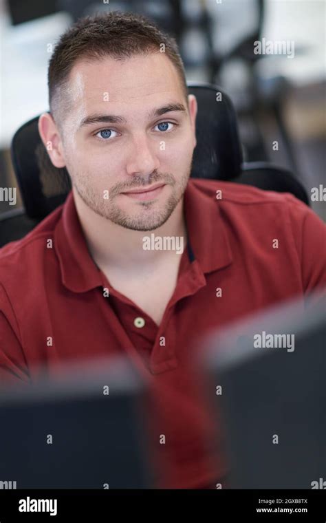 Casual Business Man Working On Desktop Computer In Modern Open Plan