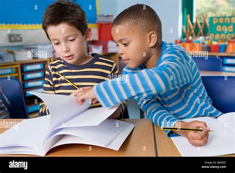 Boy Helping Friend Stock Photo Alamy